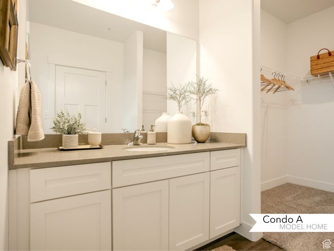 Bathroom with a spacious closet, vanity, and baseboards | Image 15