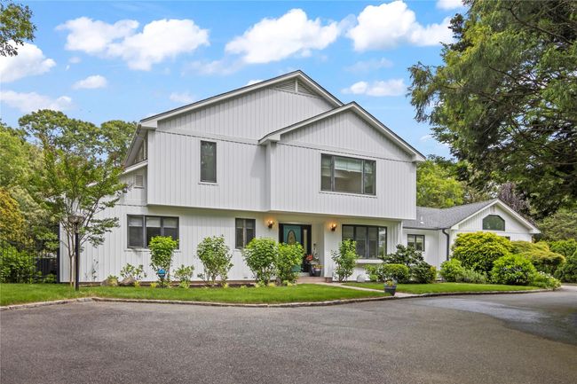 Modern farmhouse style home with a front lawn | Image 36