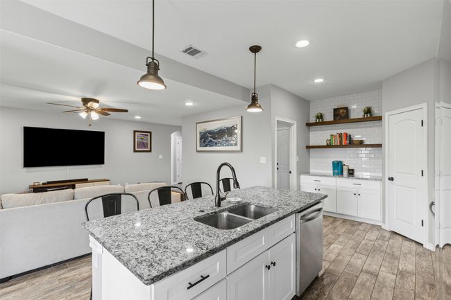 Kitchen with a sink, dishwasher, light wood finished floors, tasteful backsplash, and recessed lighting | Image 13
