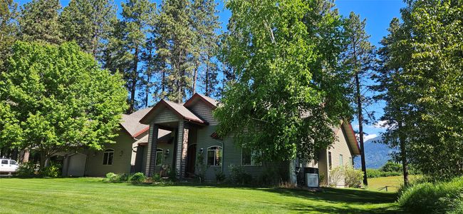 Obstructed view of property featuring a front yard and an attached garage | Image 55