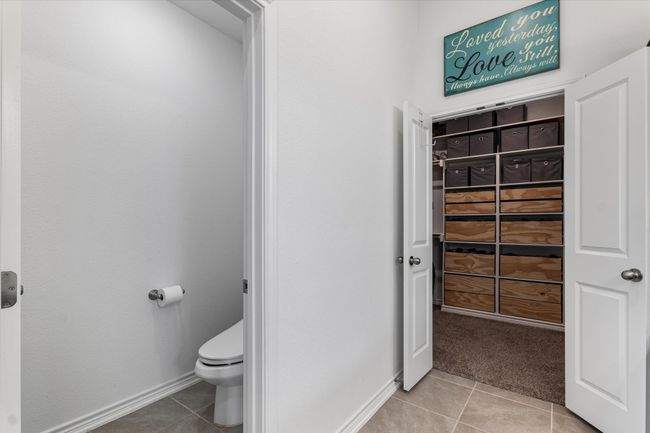 Bathroom featuring tile patterned floors, baseboards, and toilet | Image 24