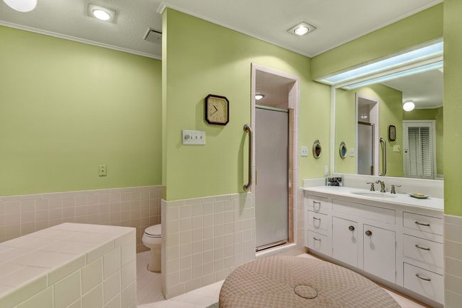 Full bathroom with vanity, a stall shower, toilet, tile walls, and tile patterned flooring | Image 23