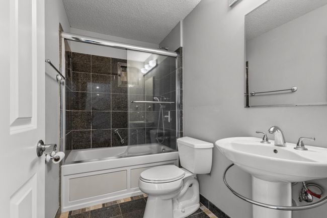 Lower level full guest bathroom with jetted tub and ceramic tile flooring is perfect for guests and everyday use. | Image 23