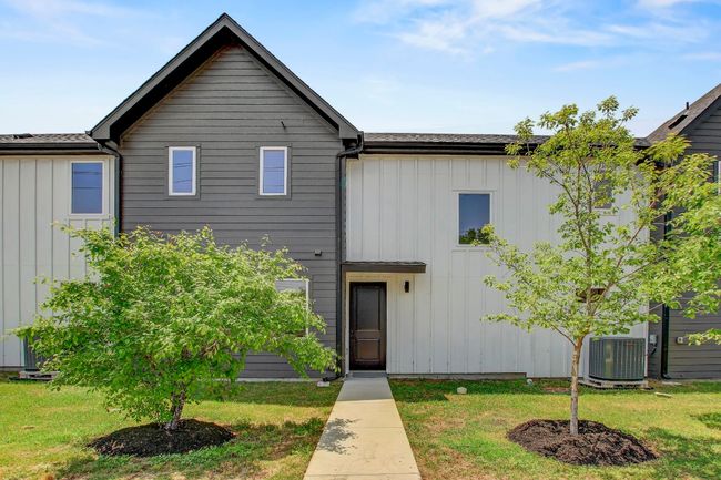 View of front of property featuring board and batten siding, central AC, and a front lawn | Image 30