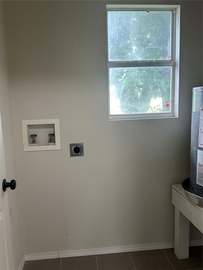 Laundry room with washer hookup, electric dryer hookup, baseboards, and tile patterned floors | Image 20