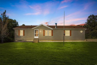 Back house at dusk with a lawn | Image 1