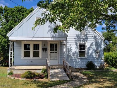 View of front of house with covered porch and a front lawn | Image 2