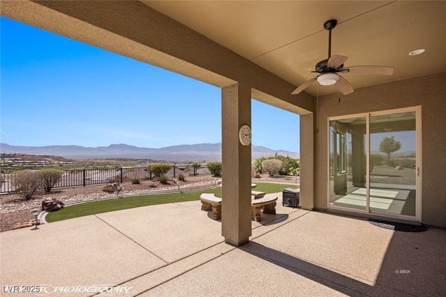 View of patio / terrace with fence, a mountain view, and a ceiling fan | Image 53