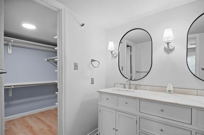 Bathroom featuring wood finished floors, vanity, and baseboards | Image 17