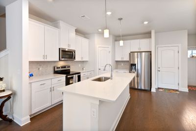 Vibrant open kitchen with plenty of cabinets and counterspace to work with! | Image 3