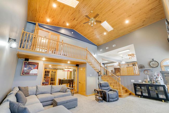 This great room also accesses the entertainment area that boasts a custom fireplace, wet bar and billiards/game table space. | Image 20