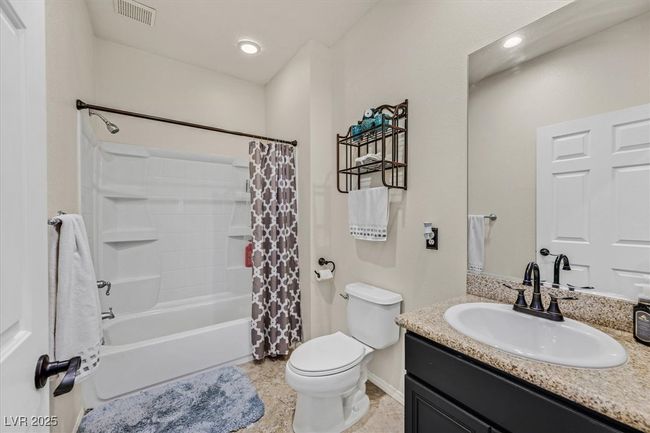 Bathroom featuring visible vents, toilet, shower / tub combo, baseboards, and vanity | Image 23