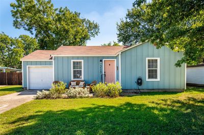 Ranch-style home with a front lawn and a garage | Image 1