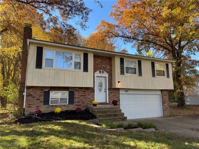 Split foyer home with a garage and a front lawn | Image 2