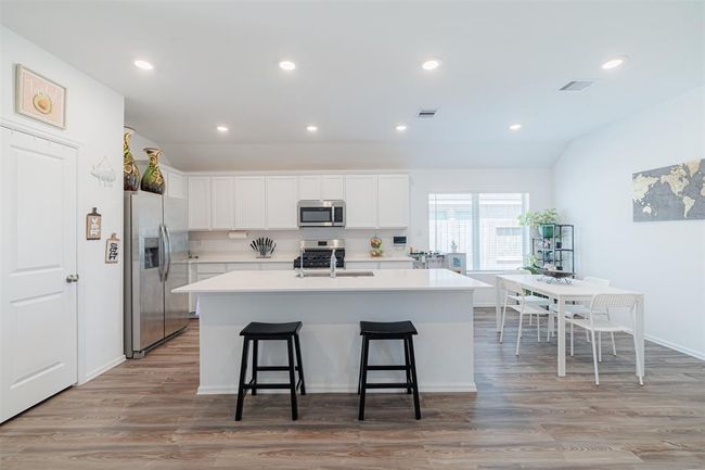 Kitchen also features recessed lighting, luxury vinyl flooring and stainless steel appliances. | Image 5