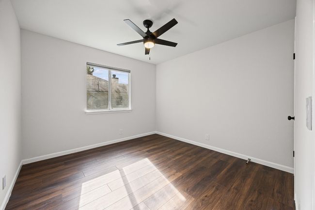 Spare room featuring dark wood finished floors and ceiling fan | Image 14