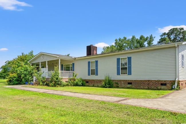 View of front of house with crawl space, a porch, a chimney, and a front lawn | Image 30