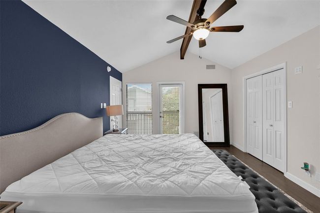 Bedroom with dark wood finished floors, ceiling fan, and a closet | Image 8