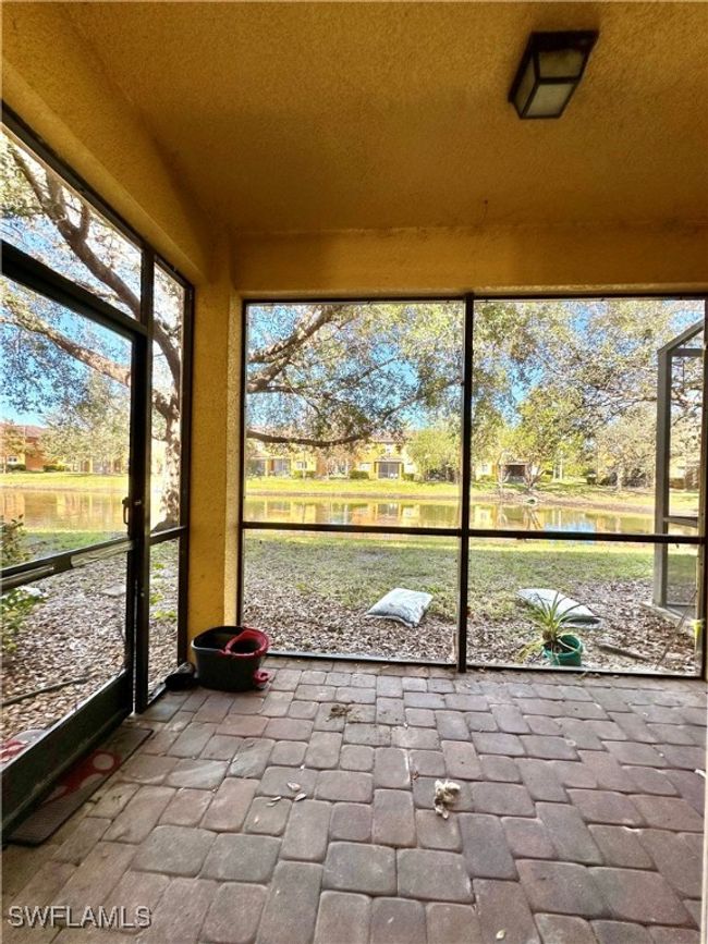 Unfurnished sunroom with a water view | Image 10