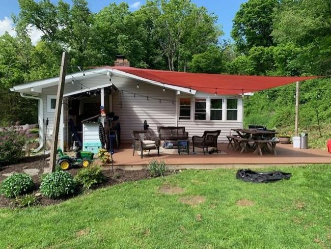 Back of house featuring a deck, a lawn, and outdoor lounge area | Image 12