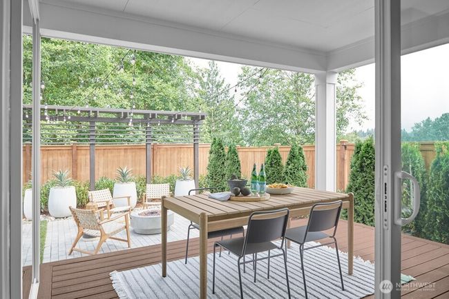 Signature Outdoor Room with wall-height sliding glass doors and composite decking. Facade, Ext Colors, Interior Photos & Floor Plans for illustrative purposes only. Actual Facade, Ext Colors, Interiors & Floor Plans may differ. | Image 8