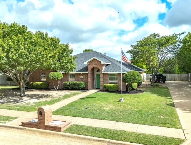 View of front of property featuring brick siding and a shingled roof | Image 5