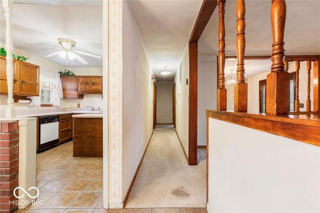 corridor featuring a sink and light tile patterned floors | Image 22