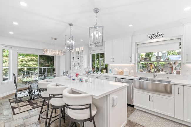 Kitchen featuring stainless steel dishwasher, backsplash, plenty of natural light, light countertops, and recessed lighting | Image 10