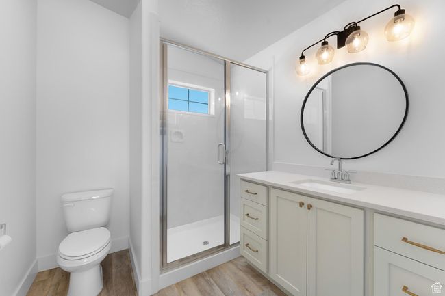 2nd floor full bath featuring vanity, wood finished floors, and a stall shower | Image 27
