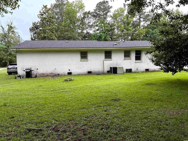 Back of property with crawl space, a yard, and central AC | Image 18
