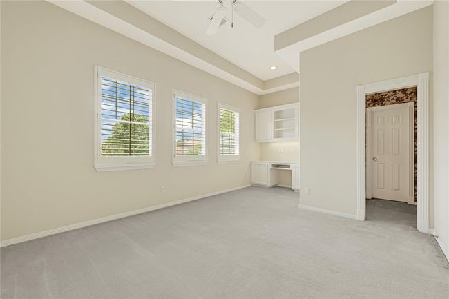 Spacious front bedroom featuring a built-in desk and convenient Jack-and-Jill bathroom access. | Image 40