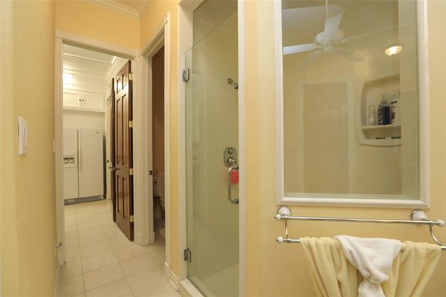The primary bathroom conveniently leads into the utility room for easy access in taking your clothes to the laundry. | Image 36