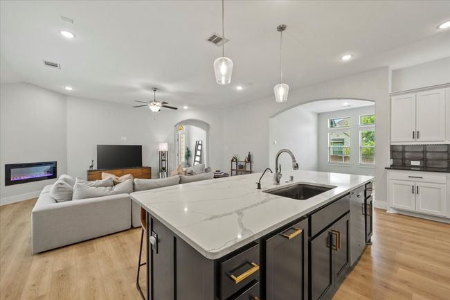 Kitchen opens onto family room and dining areas. | Image 18