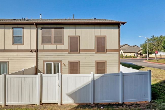 Cozy side yard is fenced and has gate access to larger common green area | Image 24