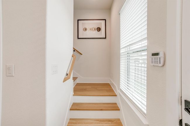 Stairs featuring baseboards, a wealth of natural light, and wood finished floors | Image 27