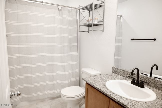 Full bathroom with tile patterned floors, vanity, and toilet | Image 16
