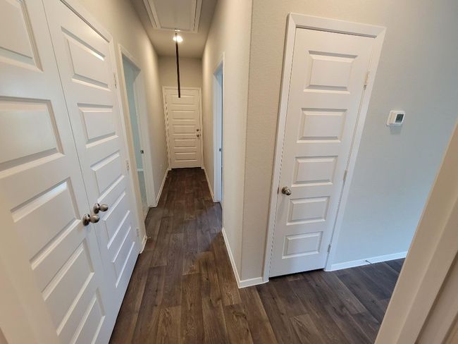 Hallway featuring dark wood finished floors and attic access | Image 14