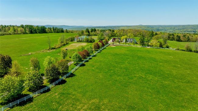 View of rural area featuring mountains and agricultural land | Image 13