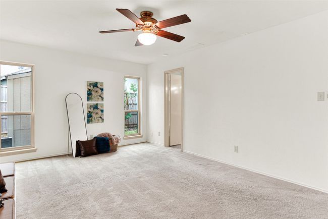 Primary bedroom featuring a ceiling fan and carpet floors | Image 21