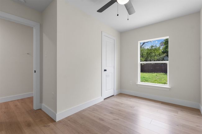 Unfurnished bedroom with light wood-type flooring and a ceiling fan | Image 24