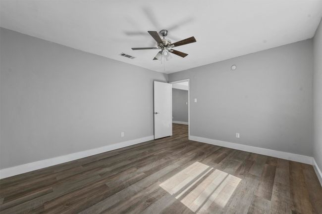 Spare room featuring ceiling fan and dark wood-type flooring | Image 20