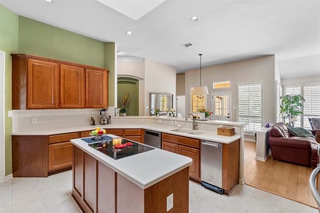 The breakfast bar acts as a natural gathering spot, connecting the kitchen to the rest of the home and making it easy to grab a quick bite or chat with friends while you cook | Image 15