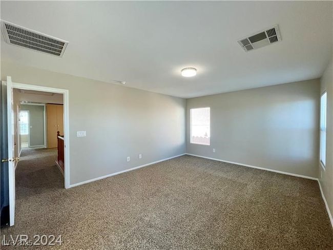 Empty room featuring visible vents, a healthy amount of sunlight, and carpet floors | Image 10
