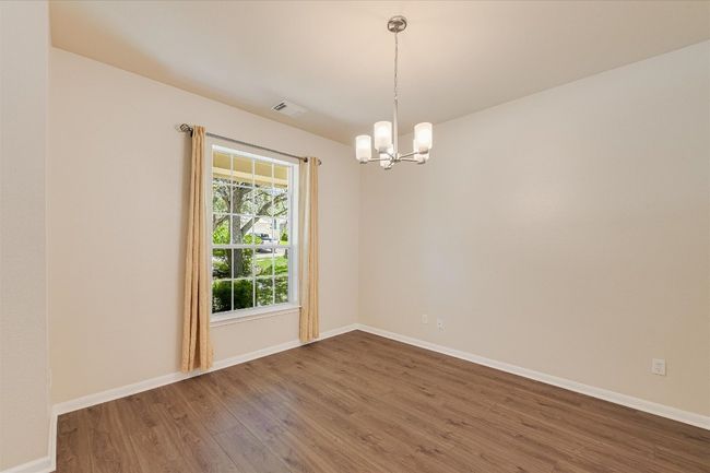 Spare room featuring a chandelier and wood finished floors | Image 5