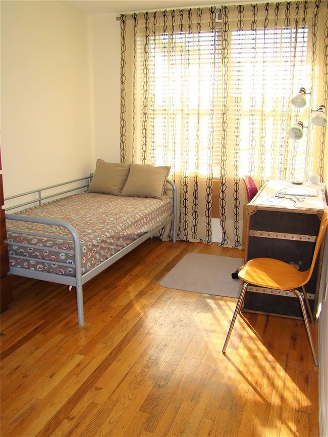 Bedroom with a baseboard radiator and hardwood / wood-style floors | Image 9