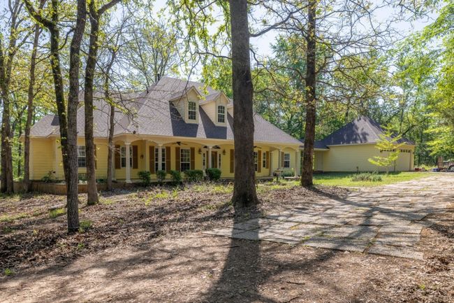 Cape cod house with dirt driveway, a shingled roof, and ceiling fan | Image 11