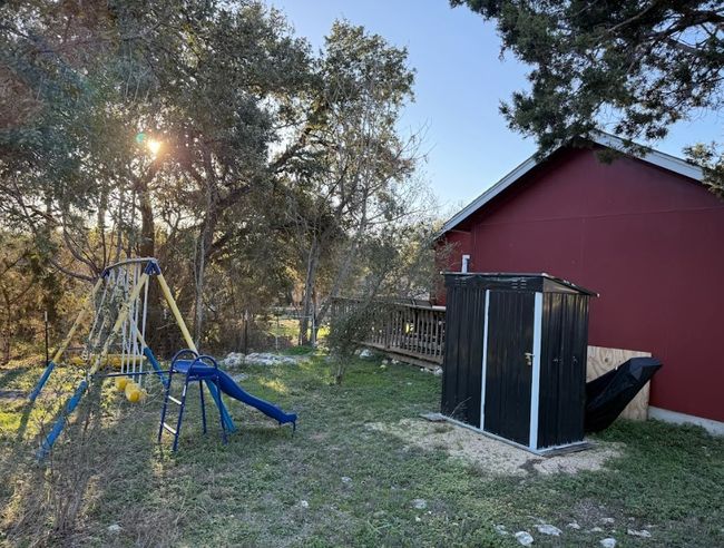 View of back yard with a playground. | Image 20