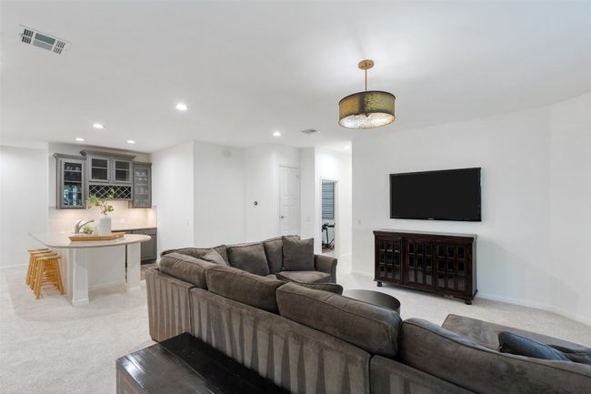 Living area with baseboards, visible vents, recessed lighting, and light colored carpet | Image 25