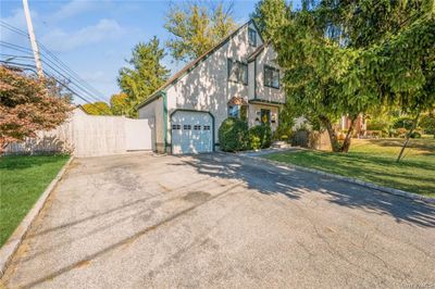 Tudor house with a front yard and a garage | Image 2