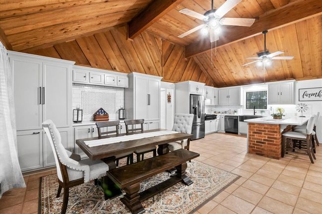 Dining room also features an incredible built-in that includes a pantry with slide out drawers and gun cabinet. | Image 10